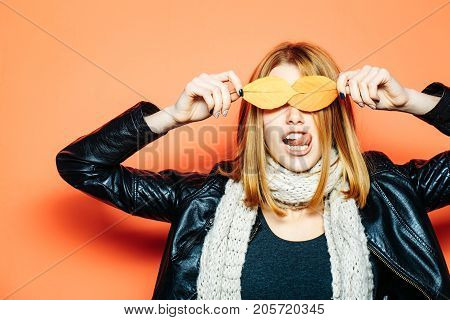 Woman With Autumn Leaves In Leather Jacket And Scarf