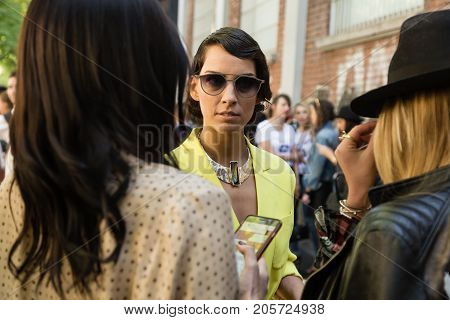 MILAN ITALY - SEPTEMBER 21: Fashionable women poses outside Fendi fashion show building during Milan Women's Fashion Week on SEPTEMBER 21 2017 in Milan.