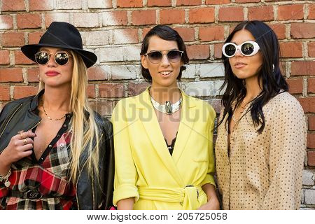 MILAN ITALY - SEPTEMBER 21: Fashionable women poses outside Fendi fashion show building during Milan Women's Fashion Week on SEPTEMBER 21 2017 in Milan.