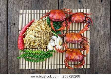 Field crab cooking ingredients on old wooden background