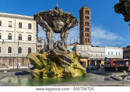 ROME, ITALY - JUNE 22, 2017:  Amazing view of Church of Santa Maria in Cosmedin and Fountain of the Tritons in city of Rome, Italy