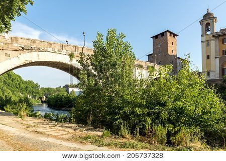 ROME, ITALY - JUNE 22, 2017: Amazing view of Castello Caetani, Tiber River and Pons Fabricius in city of Rome, Italy