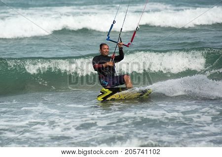 January 25 2014 Los Barriles Mexico: kiteboarder carves a turn on rough water at the 'Lord of the Wind' kite surf competition