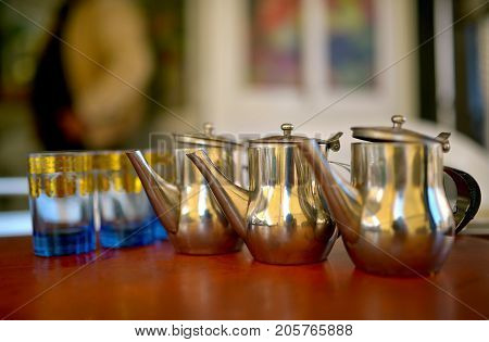 teapots for preparation of traditional tea in Morocco on a background glasses traditional cuisine of Morocco