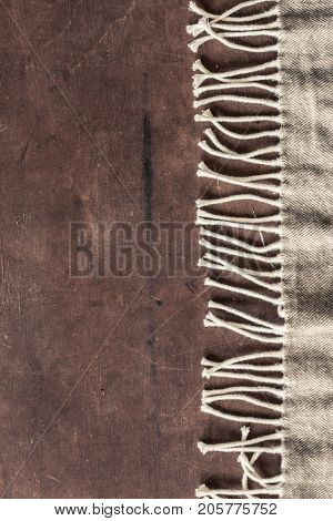 warm wool throw plaid on wooden background