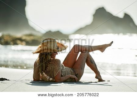 young woman relaxing on the beach in summer day