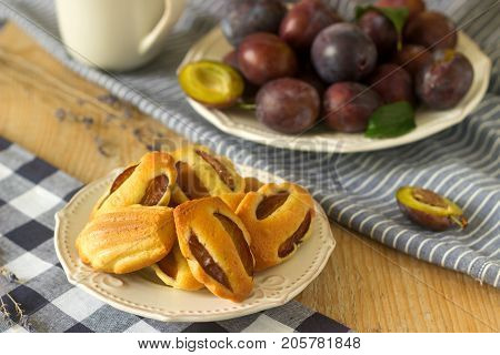 Madeleine With Plums And Plums. French Cookies. Rustic Style, Selective Focus.