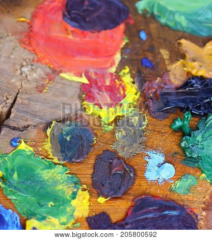 Mix of oil paints on handmade rough wooden palette.