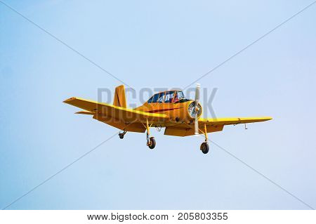 PRAGUE, CZECH REPUBLIC - 9.09.2017: One seat single engine yellow civil utility aircraft Cmelak in blue sky in Prague, Czech Republic