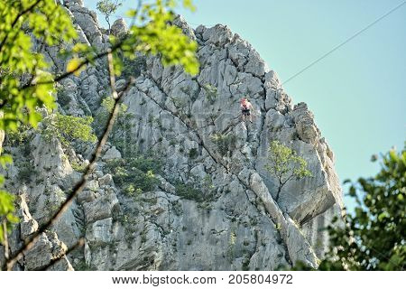 a rock climber on a rocky wall of Vrachanski Balkan Nature Park in Vratsa, Bulgaria 