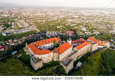 Aerial view of the Majestic Fortress - Palanok Castle towering above the city of Mukacheve, Ukraine.