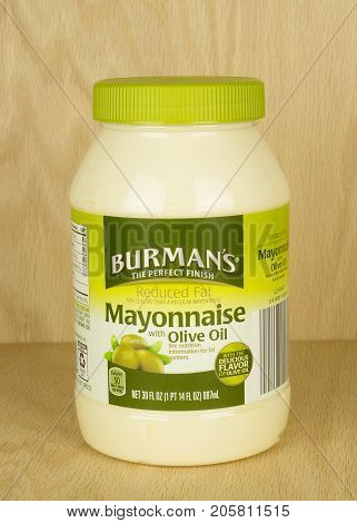 RIVER FALLS,WISCONSIN-SEPTEMBER 26,2017: A jar of Burman's brand mayonnaise with olive oil with a wood background.