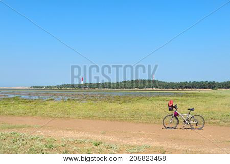 Bike and lighthouse La Coubre at the French Atlantic coast in La Palmyre 