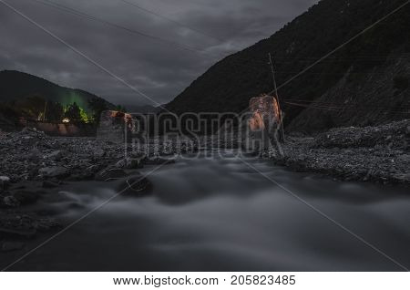 Mountain River With Stones And Grass In The Forest At The Foot Of Mountain Slope At Night In Moon Li