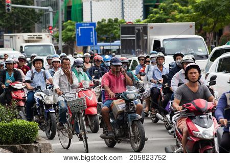 HO CHI MINH CITY (SAIGON), VIETNAM - JULY 2017 : Road traffic in Saigon, Vietnam. In the biggest city in Southern Vietnam there are more than 4 mil. motorbikes, the traffic is often congested