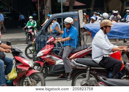HO CHI MINH CITY (SAIGON), VIETNAM - JULY 2017 : Road traffic in Saigon, Vietnam. In the biggest city in Southern Vietnam there are more than 4 mil. motorbikes, the traffic is often congested