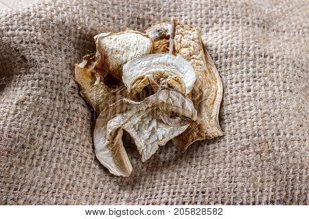 dried mushroom on sackcloth. Top view dried porcini mushrooms.