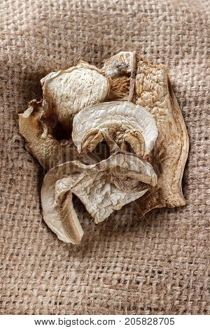 dried porcini mushrooms on sackcloth. Top view.