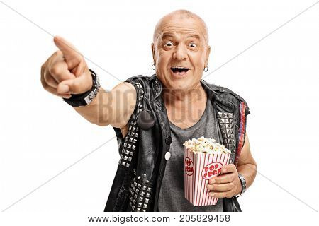 Elderly punker with a popcorn box pointing and laughing isolated on white background
