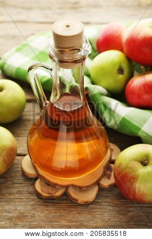 Apple Vinegar In Glass Bottle On Grey Wooden Table
