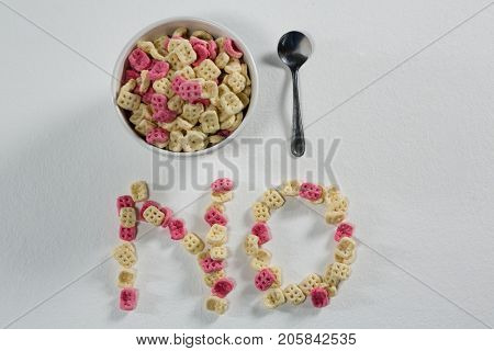 Honeycomb cereal arranged text no with bowl and spoon on white background