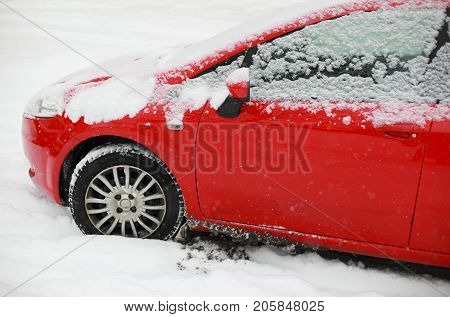 Closeup of a car covered in snow