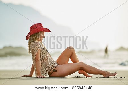 young woman relaxing on the beach in summer day