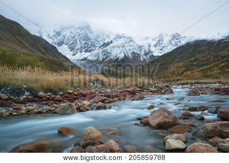 Mountain landscape. The valley of the Enguri river in autumn. The highest peak of Georgia is Shkhara. Main Caucasian ridge, Zemo Svaneti