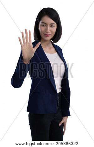 Businesswoman touching invisible screen against white background