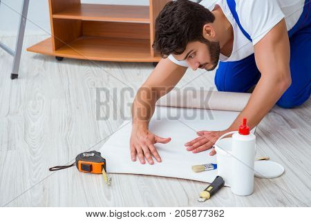 Repairman doing renovation repair in the house with paper wallpa