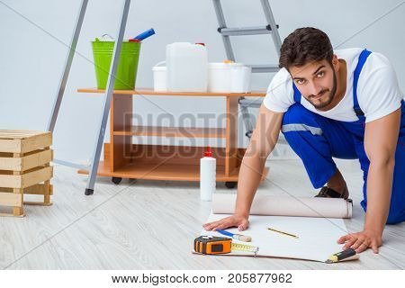 Repairman doing renovation repair in the house with paper wallpa