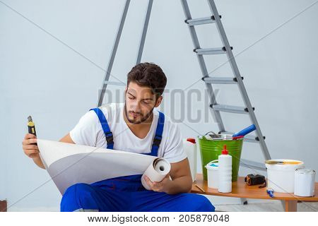 Repairman doing renovation repair in the house with paper wallpa