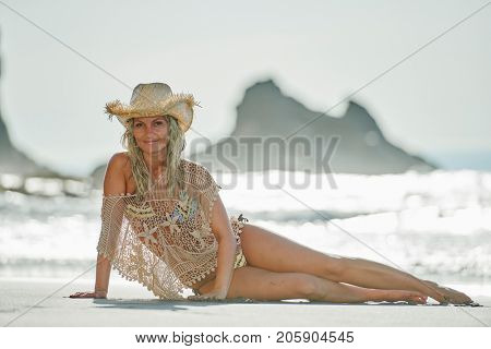 young woman relaxing on the beach in summer day
