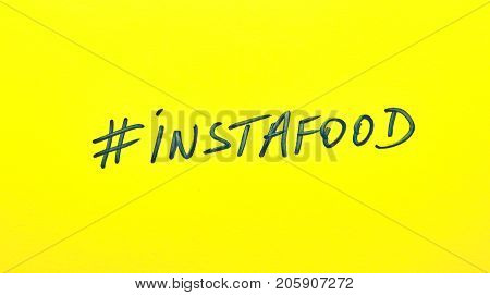 Popular hashtag instafood written on a yellow paper