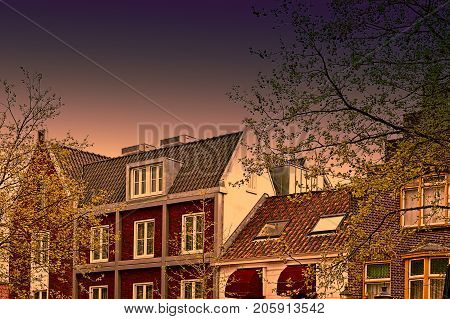 Historic buildings in the city of Amersfoort at sunset. Typical Dutch brick houses in Holland.