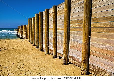 Wooden plank fence in the Israeli shore of the Mediterranean Sea. The wall separating the male and female religious part of the beach in Israel