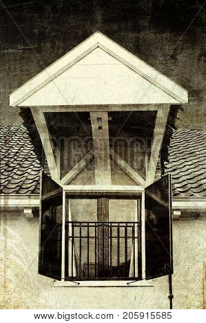 Dormer with shutters on the roof of a house in Holland. Typical dutch house with gable window painted in white and black. Vintage style toned picture