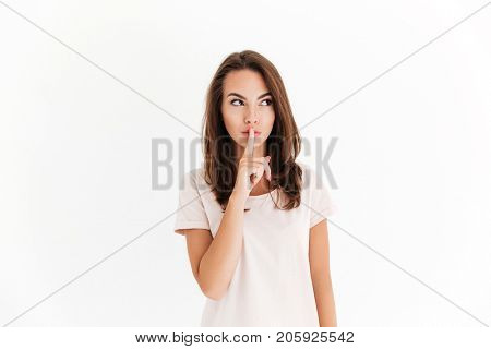 Beauty woman covering her mouth and looking away over white background