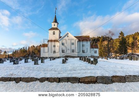 Church in march, winter landscape with snow and blue sky in Iveland in the south part of Norway