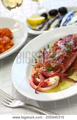 sauteed calamari with parsley and garlic, spanish tapas food