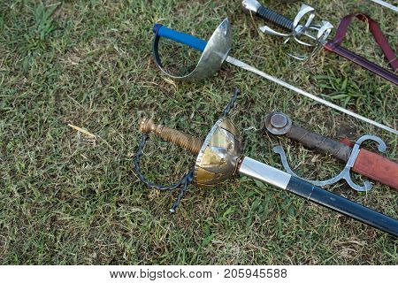 Swords and sabers on grass during the historical Reenactment in Palmanova