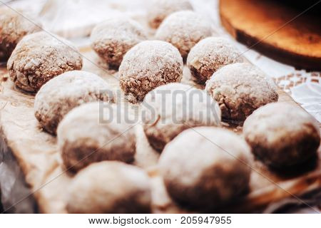 Wooden background. Uncooked turkey burgers on wooden board. Preparing dinner.