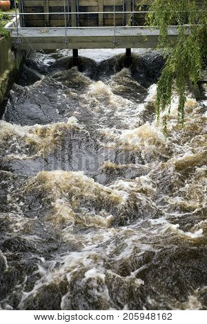 Open weir in a Danish river with a lot of water. Ribe river Denmark.