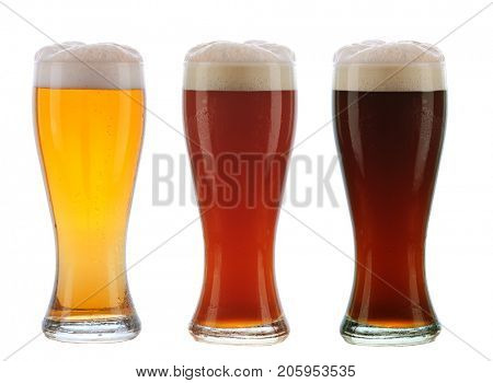 Beer: Three different beers in identical glasses with foamy tops and condensation.