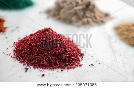 Pile of maqui berry powder on white background