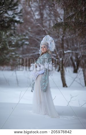 woman in a Snow Maiden costume in a winter forest