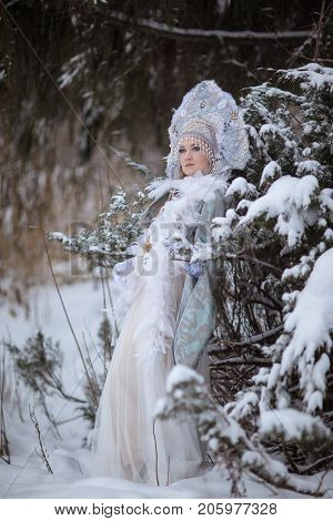 woman in a Snow Maiden costume in a winter forest