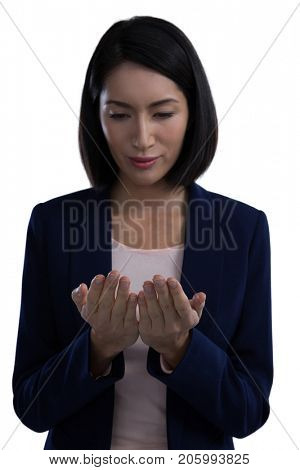 Businesswoman pretending to hold invisible object against white background