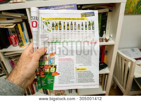 Paris, France - Mar 16, 2019: Man Hand Reading 60 Million De Consommateur Review Magazine Newspaper 