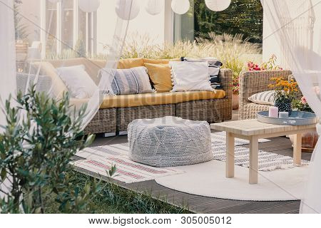 Terrace Design Idea With Rattan Garden Furniture Set And Cozy Pillows And Rug, Real Photo